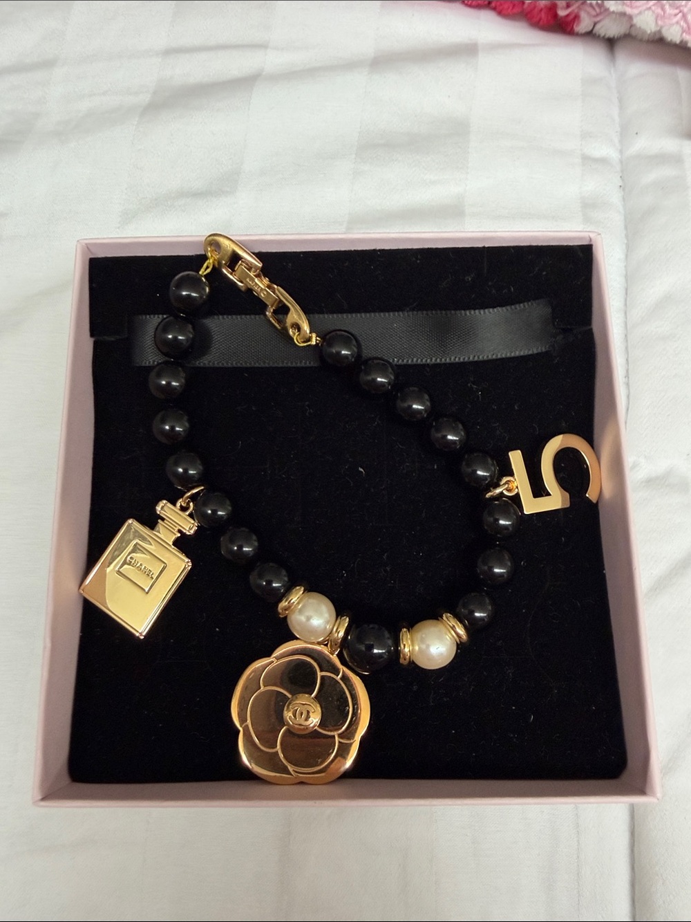 Napier Black Beaded Bracelet with Gold Flower, Pearl & Number Charms